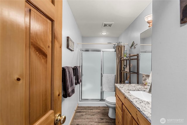 18880 Pine Loop, Leavenworth, WA 98826 - bathroom with vanity, a shower stall, toilet, and wood finished floors
