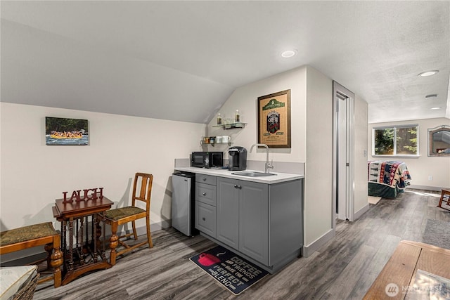 18880 Pine Loop, Leavenworth, WA 98826 - indoor wet bar with black microwave, dishwasher, wood finished floors, baseboards, and recessed lighting