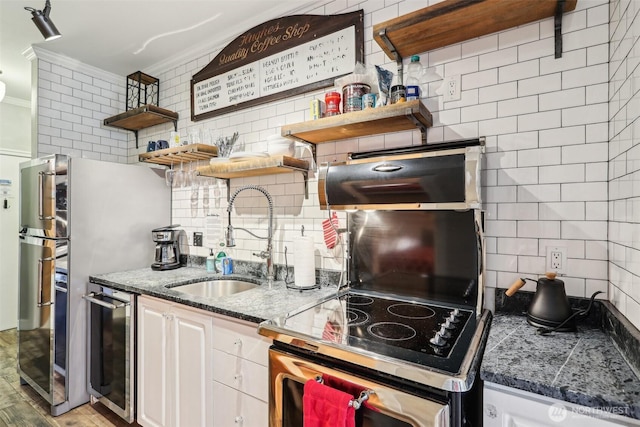 2415 2nd Ave Unit 543, Seattle, WA 98121 - kitchen with crown molding, stove, a sink, tasteful backsplash, and open shelves