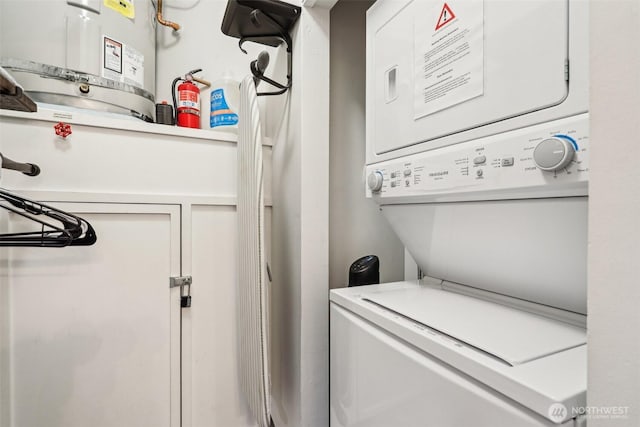 2415 2nd Ave Unit 543, Seattle, WA 98121 - washroom featuring stacked washer / drying machine and water heater