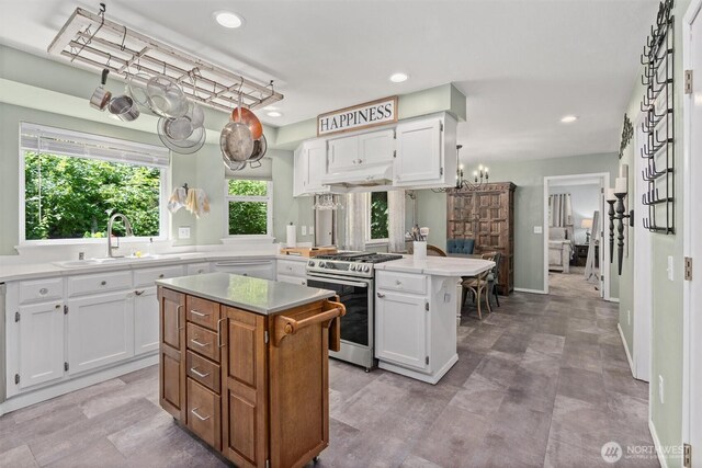 4628 109th Ave SE, Snohomish, WA 98290 - kitchen featuring gas range, a center island, a sink, white cabinets, and recessed lighting