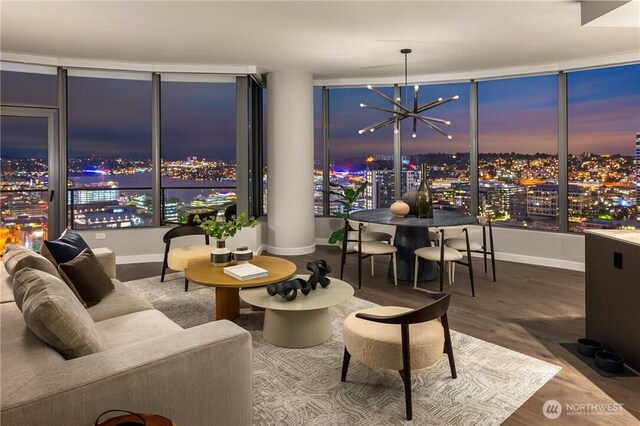2510 6th Ave Unit 2802, Seattle, WA 98121 - living area featuring a view of city, a chandelier, baseboards, and wood finished floors