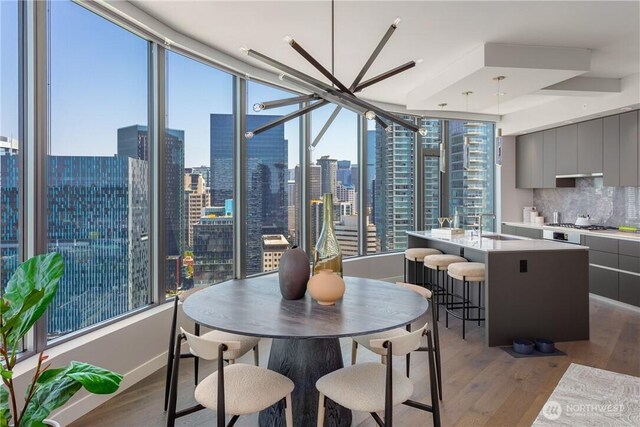 2510 6th Ave Unit 2802, Seattle, WA 98121 - dining area with wood finished floors and a view of skyline