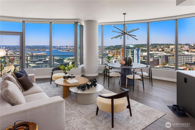 2510 6th Ave Unit 2802, Seattle, WA 98121 - living area featuring a view of city, wood finished floors, and baseboards