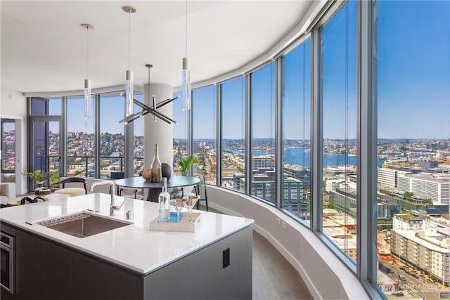 2510 6th Ave Unit 2802, Seattle, WA 98121 - kitchen featuring a sink, a city view, a center island with sink, and dark wood finished floors