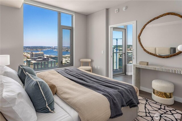 2510 6th Ave Unit 2802, Seattle, WA 98121 - bedroom featuring multiple windows, access to exterior, and wood finished floors
