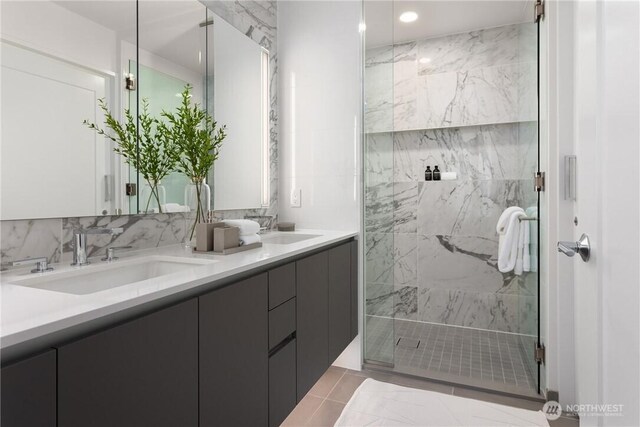 2510 6th Ave Unit 2802, Seattle, WA 98121 - bathroom with a marble finish shower, double vanity, and recessed lighting