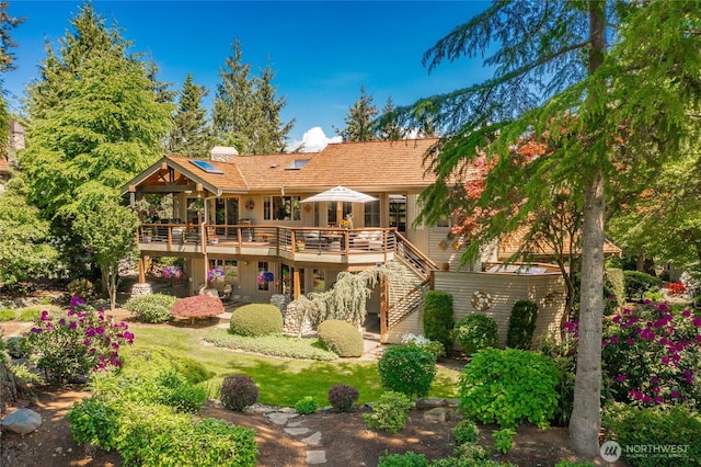 8789 Wood Duck Way, Blaine, WA 98230 - back of house featuring a deck, stairs, a lawn, and a chimney