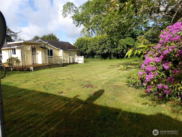 1707 258th Pl, Ocean Park, WA 98640 - view of grassy yard with a deck