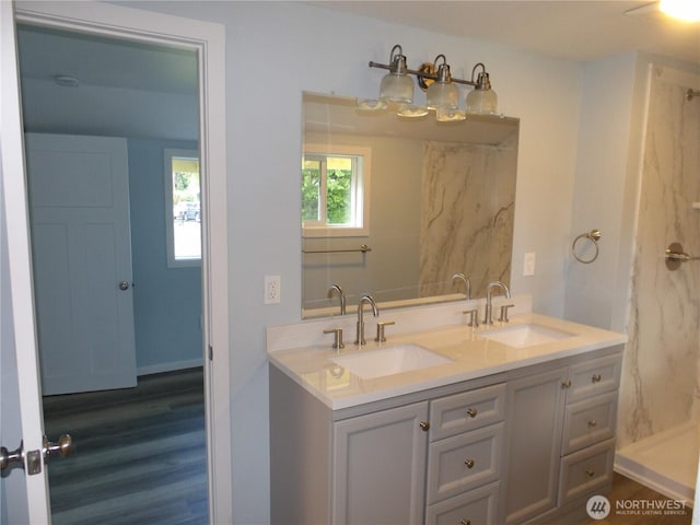 1707 258th Pl, Ocean Park, WA 98640 - bathroom featuring double vanity, wood finished floors, and a shower