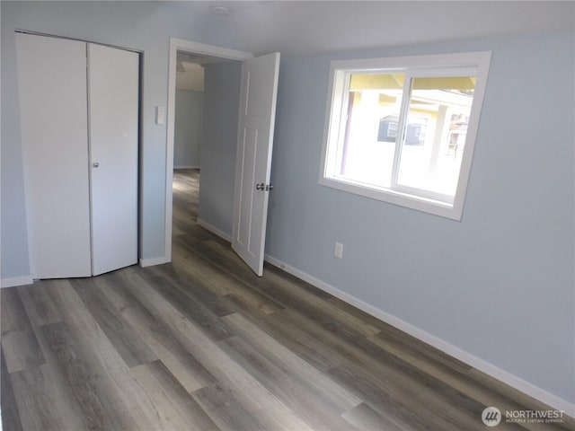 1707 258th Pl, Ocean Park, WA 98640 - unfurnished bedroom featuring baseboards, wood finished floors, and a closet