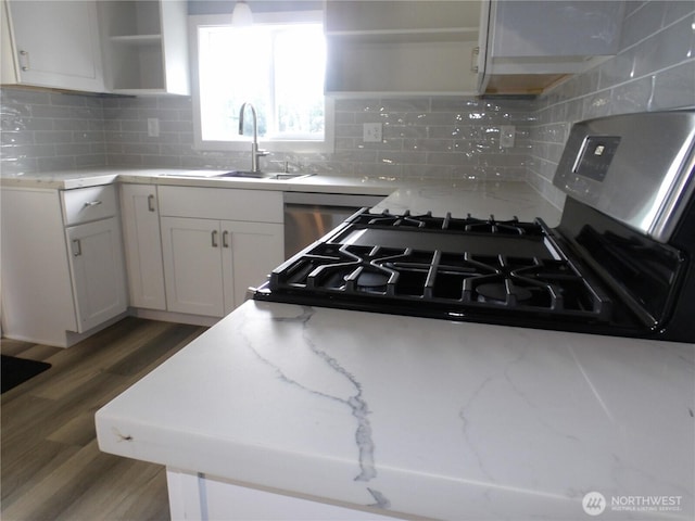 1707 258th Pl, Ocean Park, WA 98640 - kitchen featuring a sink, open shelves, wood finished floors, white cabinetry, and gas range oven