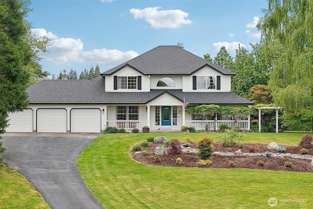 8906 NE 275th St, Battle Ground, WA 98604 - traditional-style home featuring covered porch, an attached garage, asphalt driveway, and a front lawn