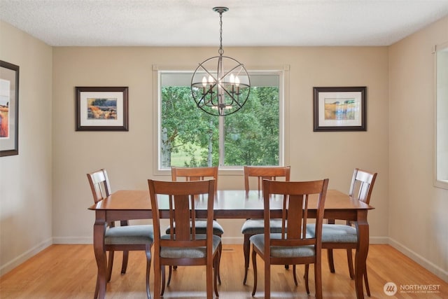 8906 NE 275th St, Battle Ground, WA 98604 - dining area with light wood-style floors, a chandelier, and baseboards