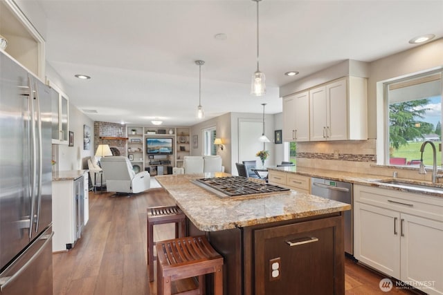 8906 NE 275th St, Battle Ground, WA 98604 - kitchen featuring stainless steel appliances, a sink, a breakfast bar, open floor plan, and recessed lighting