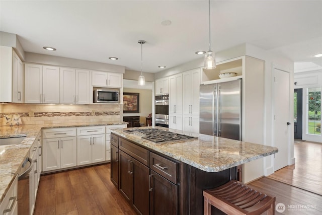 8906 NE 275th St, Battle Ground, WA 98604 - kitchen with appliances with stainless steel finishes, dark wood finished floors, white cabinets, dark brown cabinetry, and recessed lighting