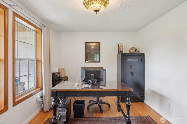 8906 NE 275th St, Battle Ground, WA 98604 - office area featuring light wood-style flooring, a textured ceiling, and baseboards