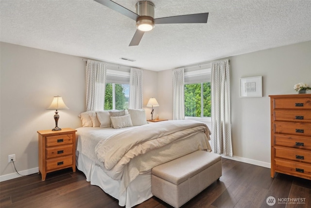 8906 NE 275th St, Battle Ground, WA 98604 - bedroom with dark wood-type flooring, baseboards, ceiling fan, and a textured ceiling