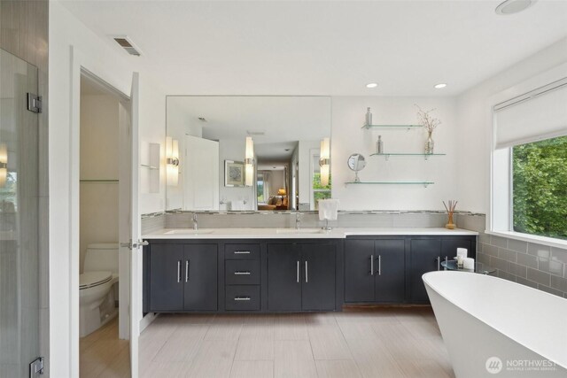 8906 NE 275th St, Battle Ground, WA 98604 - bathroom featuring double vanity, a soaking tub, toilet, and a shower stall