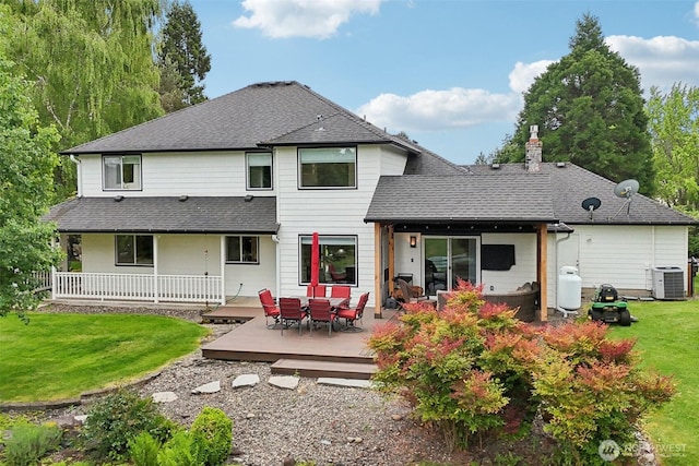 8906 NE 275th St, Battle Ground, WA 98604 - back of house with cooling unit, a chimney, a yard, roof with shingles, and a deck