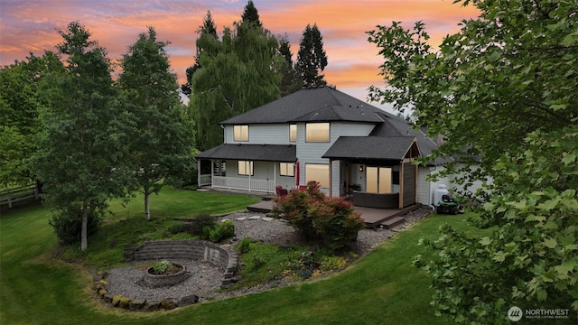 8906 NE 275th St, Battle Ground, WA 98604 - back of property with covered porch, a lawn, and a shingled roof