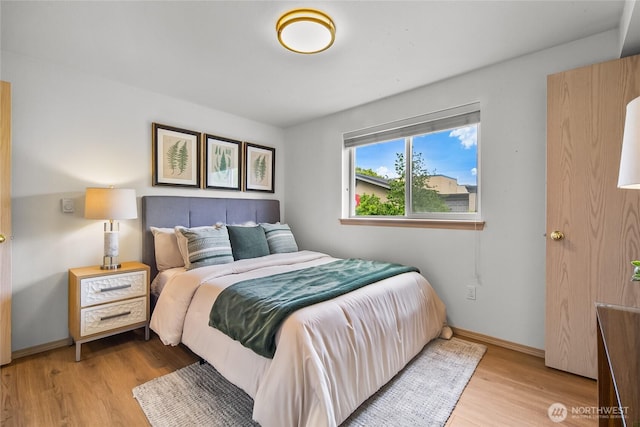 12056 15th Ave NE Unit 204, Seattle, WA 98125 - bedroom featuring wood finished floors and baseboards