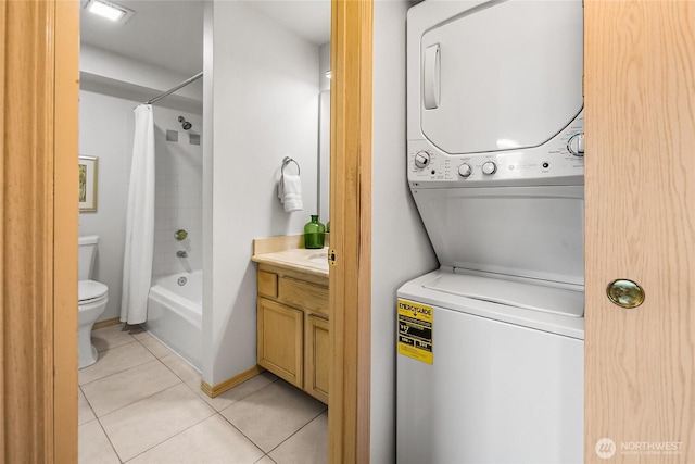 12056 15th Ave NE Unit 204, Seattle, WA 98125 - laundry area featuring stacked washer / drying machine and light tile patterned floors
