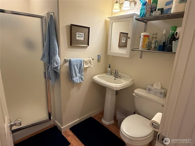 30511 M Pl, Ocean Park, WA 98640 - bathroom featuring a shower stall, wood finished floors, toilet, and baseboards