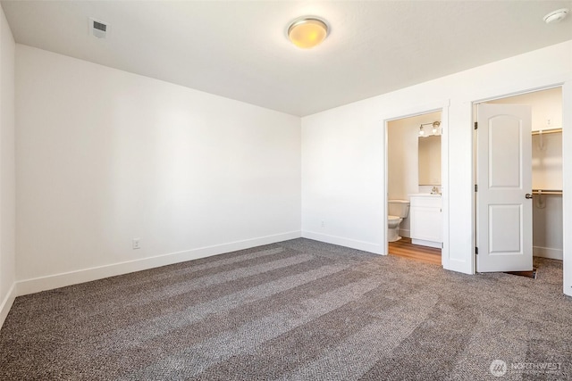 311 W Sandy Loop, Moses Lake, WA 98837 - unfurnished bedroom with carpet flooring, a walk in closet, and ensuite bath