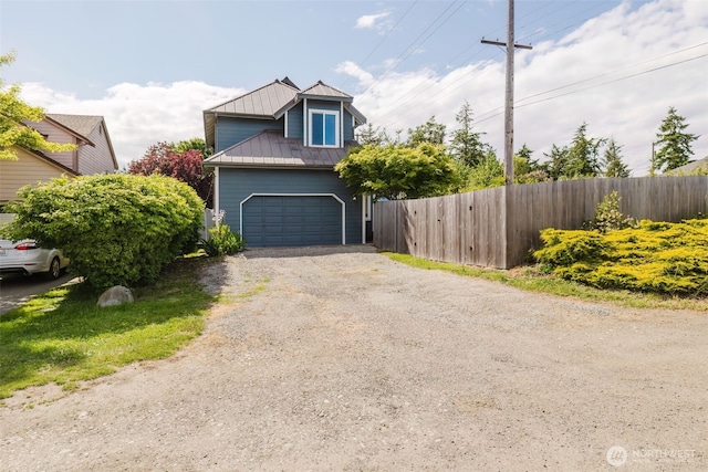 1819 Kuhn St, Port Townsend, WA 98368 - view of front of property with driveway, metal roof, a standing seam roof, and an attached garage