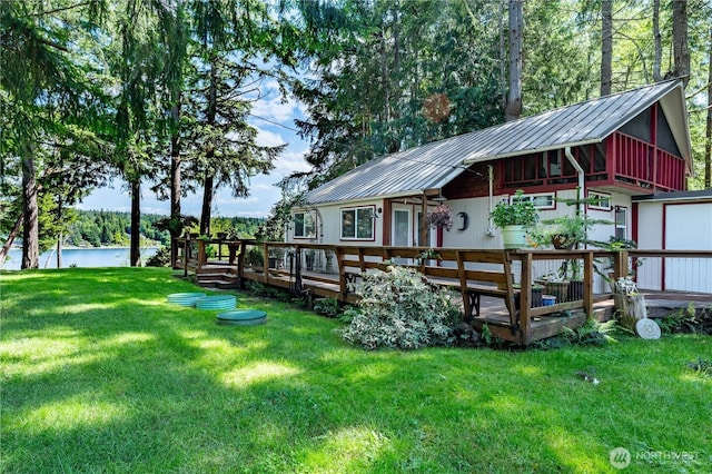 711 E Herron Blvd NW, Lakebay, WA 98349 - rear view of property featuring a deck with water view, metal roof, and a lawn