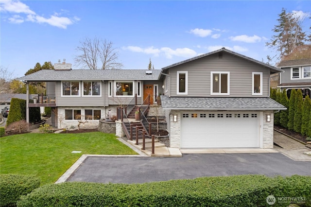 9317 192nd Pl SW, Edmonds, WA 98020 - split level home with an attached garage, stone siding, a chimney, asphalt driveway, and a front yard