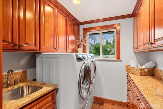 9317 192nd Pl SW, Edmonds, WA 98020 - laundry area with cabinet space, separate washer and dryer, crown molding, and light wood-style flooring