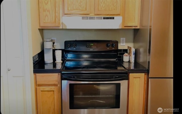 1009 112th St Unit D304, Everett, WA 98208 - kitchen with exhaust hood, stainless steel appliances, dark countertops, and light brown cabinetry