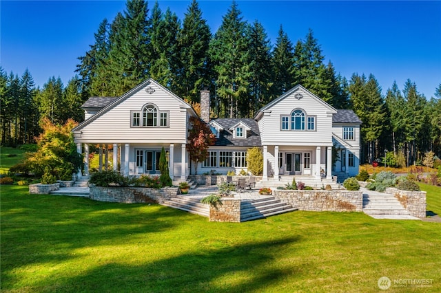 12907 Moss Creek Ln NE, Carnation, WA 98014 - rear view of property featuring covered porch, a chimney, french doors, and a yard