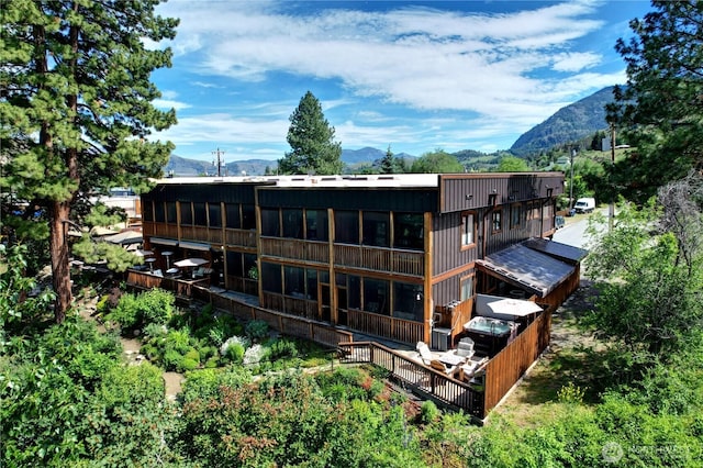 140 Twisp Ave W Unit 204, Twisp, WA 98856 - rear view of house featuring a sunroom and a mountain view