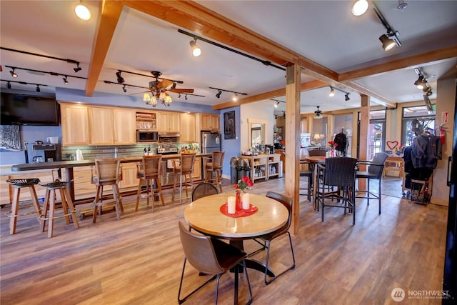 140 Twisp Ave W Unit 204, Twisp, WA 98856 - dining room with track lighting, a ceiling fan, light wood finished floors, and beamed ceiling