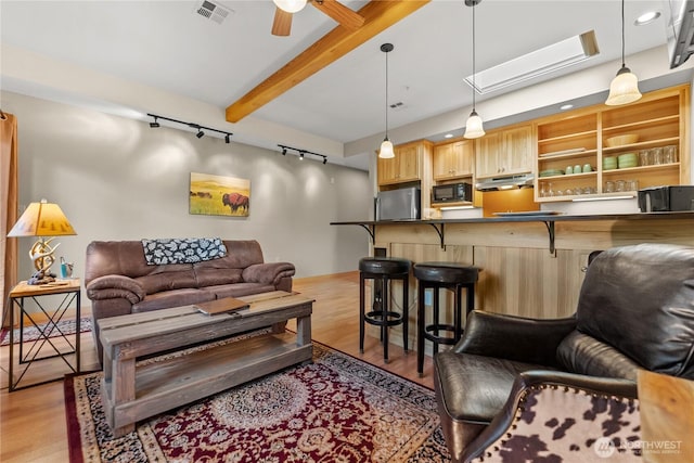 140 Twisp Ave W Unit 204, Twisp, WA 98856 - living area featuring rail lighting, light wood-style floors, beamed ceiling, ceiling fan, and a skylight