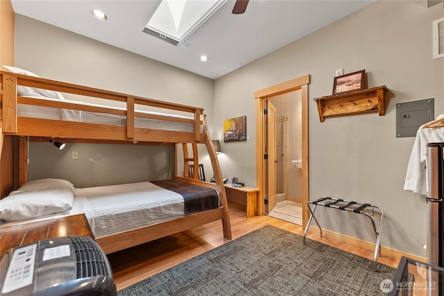 140 Twisp Ave W Unit 204, Twisp, WA 98856 - bedroom with a skylight, light wood-type flooring, baseboards, electric panel, and recessed lighting