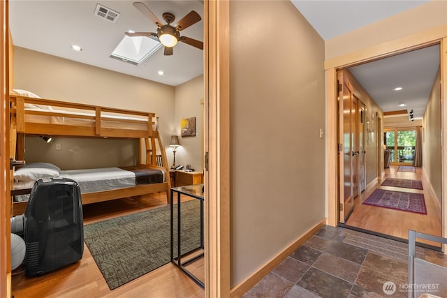140 Twisp Ave W Unit 204, Twisp, WA 98856 - bedroom with baseboards, a skylight, recessed lighting, stone finish flooring, and ceiling fan