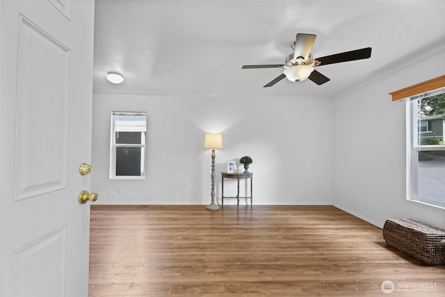 23708 Locust Way Unit 26B, Bothell, WA 98021 - empty room with crown molding, ceiling fan, wood finished floors, and baseboards