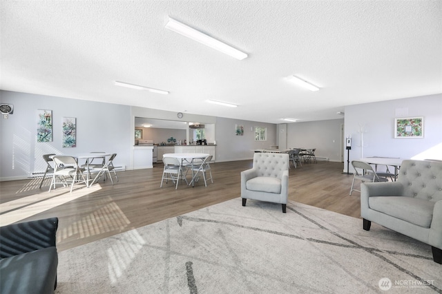 23708 Locust Way Unit 26B, Bothell, WA 98021 - living area featuring a textured ceiling, wood finished floors, and baseboards
