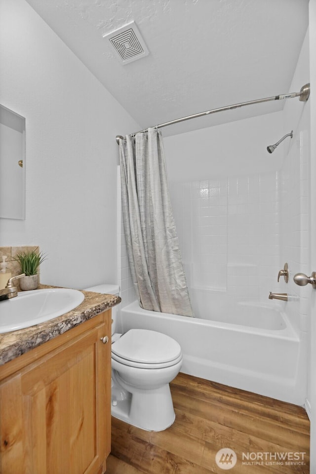 23708 Locust Way Unit 26B, Bothell, WA 98021 - bathroom with shower / bath combination with curtain, vanity, toilet, wood finished floors, and lofted ceiling