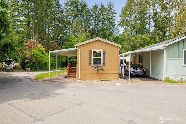 23708 Locust Way Unit 26B, Bothell, WA 98021 - view of outdoor structure with a carport and view of scattered trees