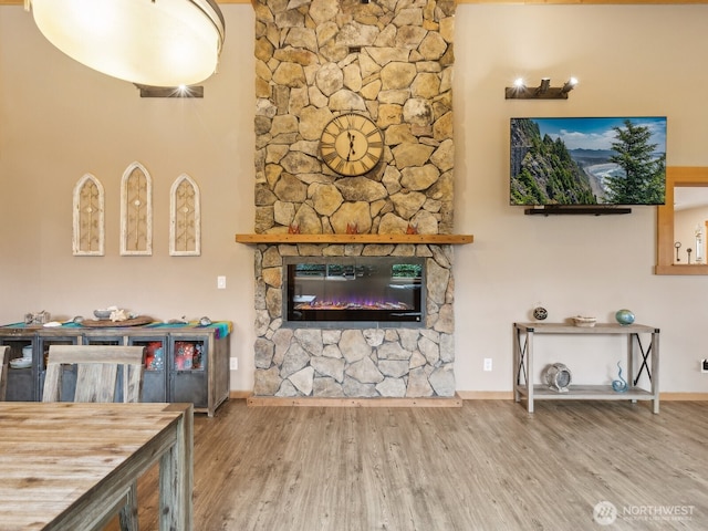 957 SW Camano Dr, Camano Island, WA 98282 - living room featuring wood finished floors, baseboards, and a stone fireplace