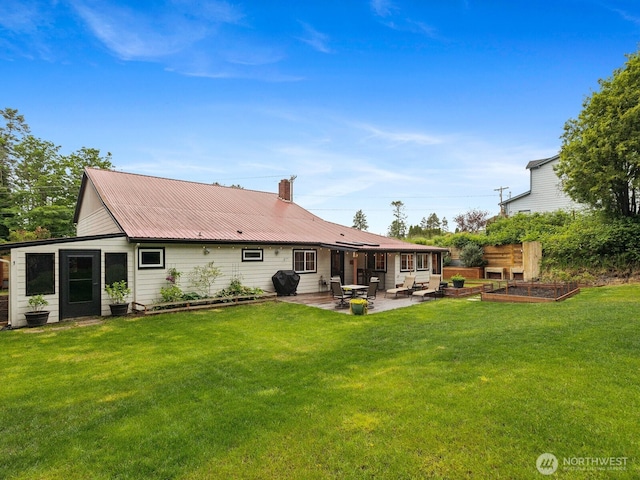 957 SW Camano Dr, Camano Island, WA 98282 - rear view of property with a garden, a patio, a yard, and metal roof