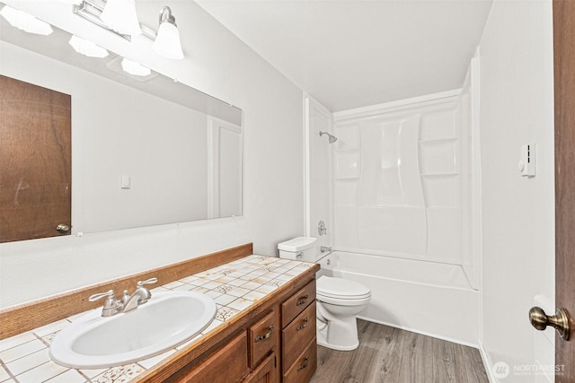 7391 E Grandview St, Port Orchard, WA 98366 - full bathroom featuring vanity, toilet, wood finished floors, and tub / shower combination