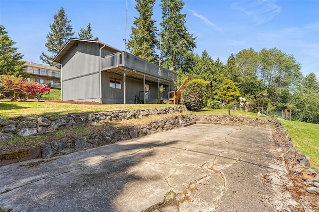 7391 E Grandview St, Port Orchard, WA 98366 - rear view of property with a deck, a patio, and a lawn