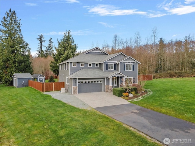 31632 19th Dr NW, Stanwood, WA 98292 - view of front of home with stone siding, concrete driveway, board and batten siding, and an attached garage