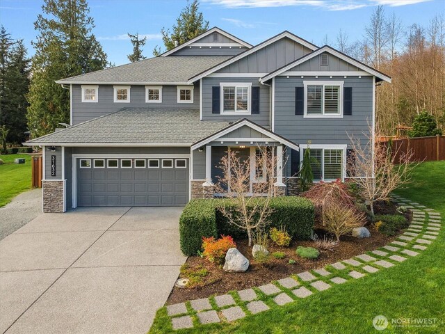 31632 19th Dr NW, Stanwood, WA 98292 - craftsman inspired home with driveway, board and batten siding, stone siding, roof with shingles, and a garage